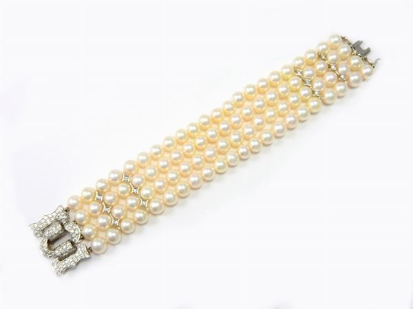 Four strands cultured pearls bracelet with white gold clasp and links set with diamonds