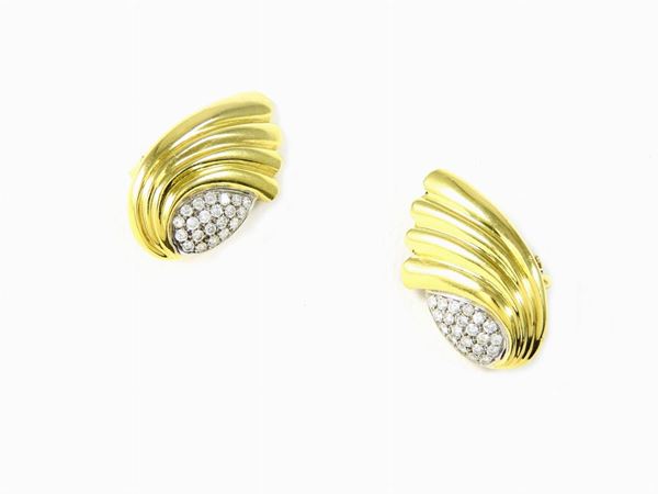 Yellow gold rimmed earclips with diamonds