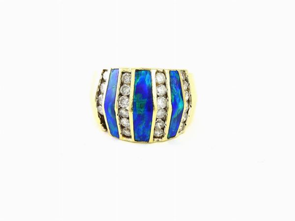 Yellow gold band ring with diamonds and black opal ornaments