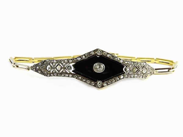 White and yellow gold Art Deco bracelet with diamonds and onyx