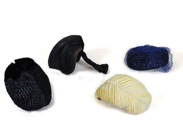 Two woven straw hats and two hair ornaments