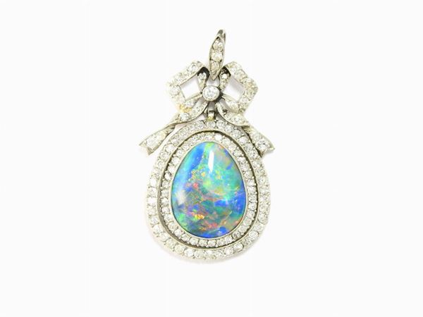 White gold pendant set with old cut diamonds and drop cut gem quality opal