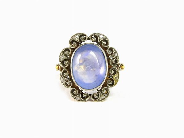 Yellow and white gold ring with small diamonds and star sapphire