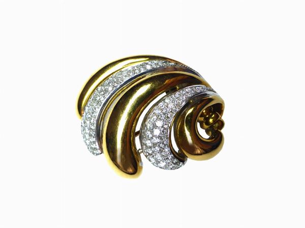 Yellow and white gold voluted brooch with diamonds