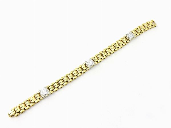 Yellow gold curb link bracelet with three diamonds set in white gold