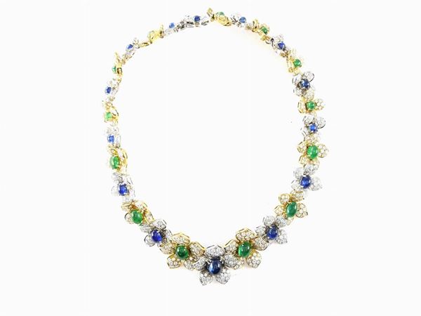 Parure of white and yellow gold necklace, bracelet and earrings with diamonds,sapphires and emeralds