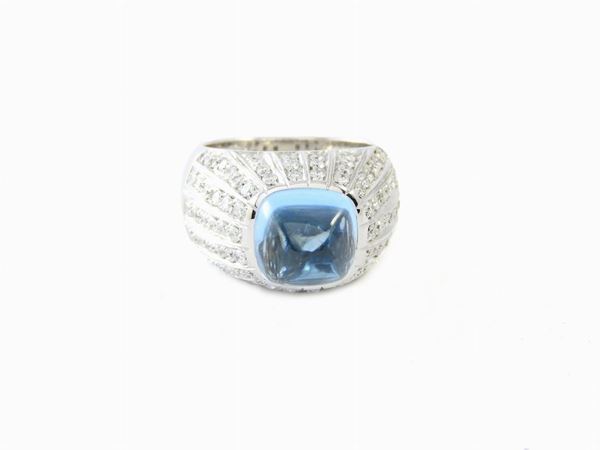 White gold ring with diamonds and blue topas