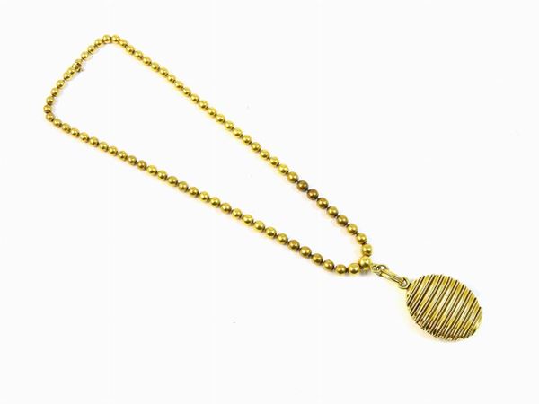 Yellow gold graduated beads necklace with locket pendant