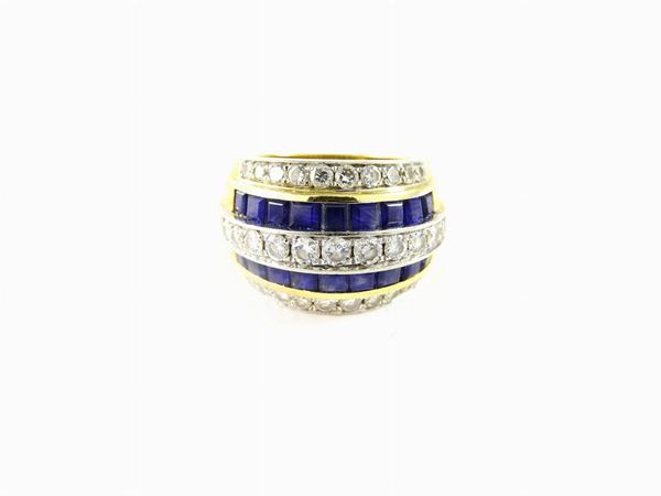 White and yellow gold band ring with diamonds and sapphires