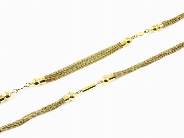 Yellow gold necklace of thin chains with panels