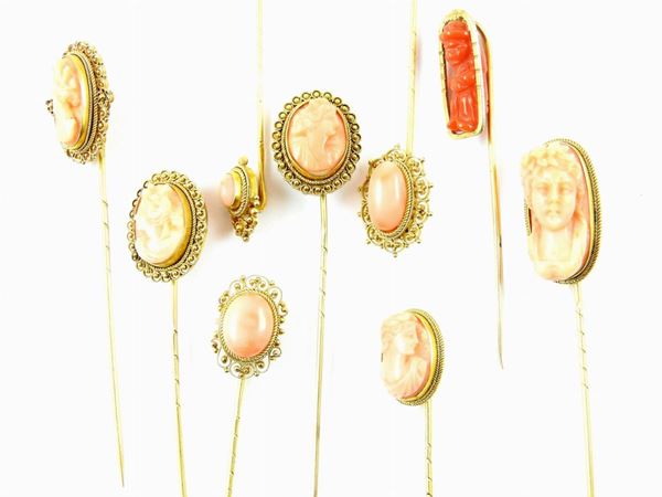 Nine filigree 12 kt yellow gold pins with red and pink coral cameos or cabochons