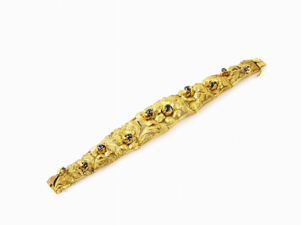 Yellow gold semi rigid bracelet with sapphires