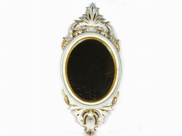 An Oval Lacquered and Giltwood Mirror