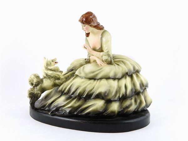 A Polychrome Ceramic Figure of a Lady With Dog