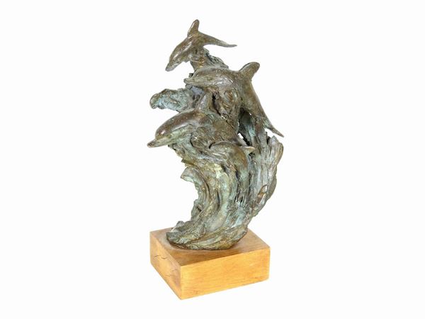 A Patinated Bronze Sculpture With Dolphins