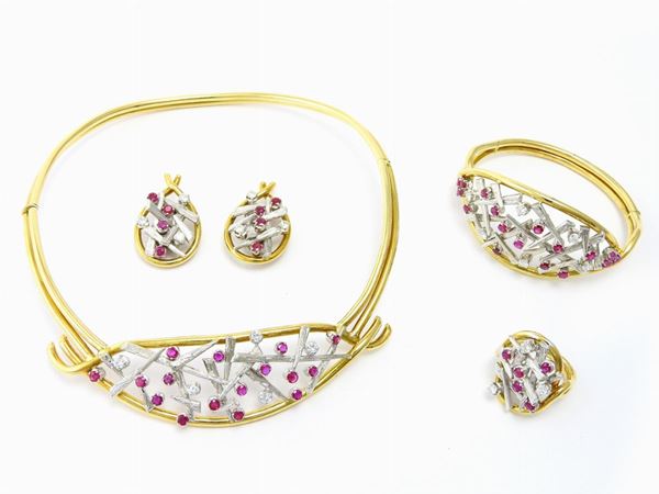 White and yellow gold parure of necklace, bangle, earrings and ring set with diamonds and rubies