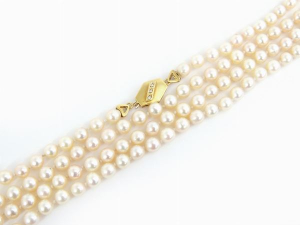 Long Akoya cultured pearls necklace with yellow gold clasp set with diamonds