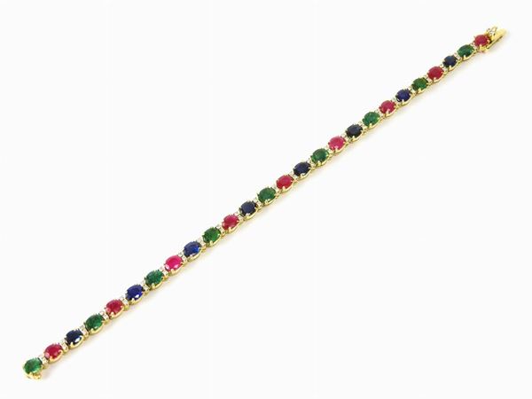 Yellow gold tennis bracelet with diamonds, rubies, sapphires and emeralds