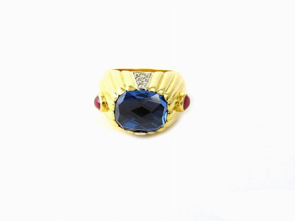 Yellow gold ring with diamonds, blue topaz and rubies