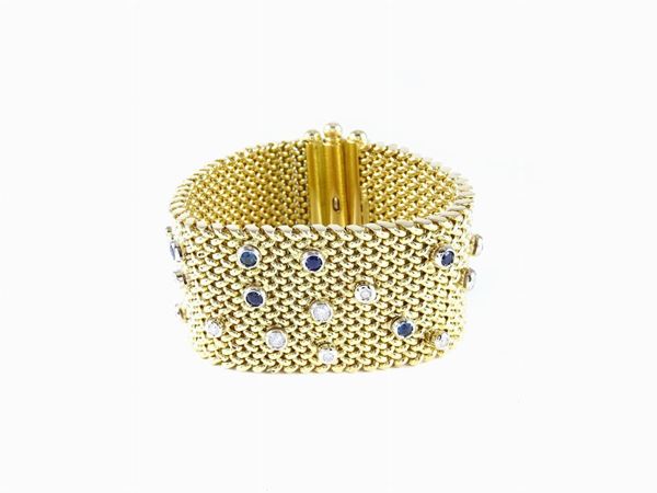 Yellow gold woven band bracelet with diamonds and sapphires