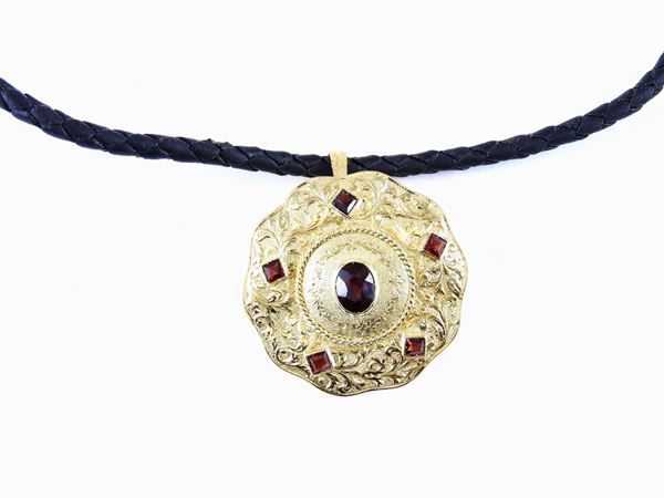 Braided leather necklace with yellow gold clasp and brooch/pendant set with garnets