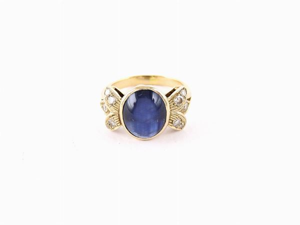White gold ring with diamonds and sapphire
