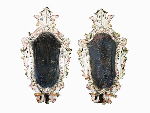 A Pair of Polychrome Ceramic Mirrors with Candle Holders