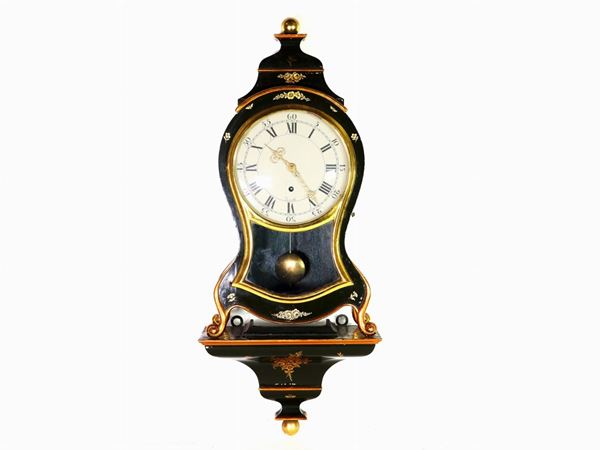 A Lacquered and Partially Giltwood Cartel Clock
