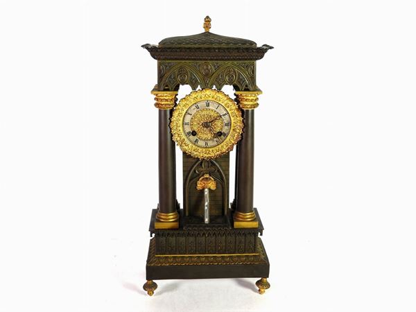 A Patinated and Gilded Metal Mantel Clock