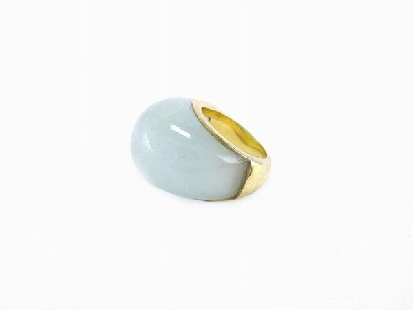 Yellow gold band ring with milky aquamarine