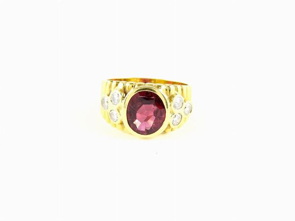 Yellow gold rimmed ring with ruby and diamonds