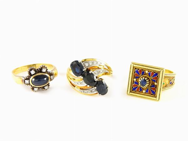 Three white and yellow gold rings with multicoloured enamels, diamonds, sapphires