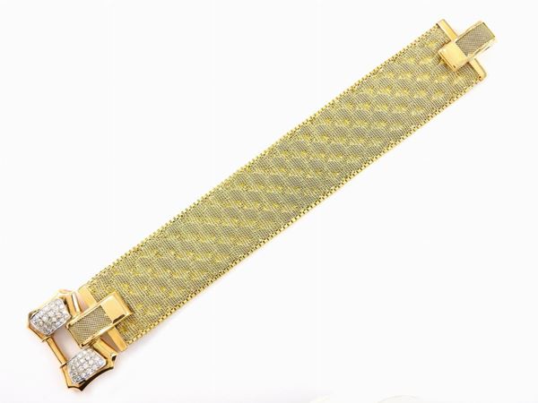 Yellow gold woven bracelet, bow-shaped clasp set with diamonds