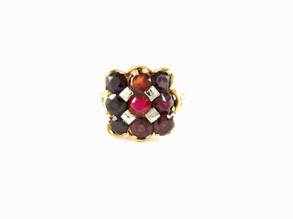 White and yellow gold ring with garnets