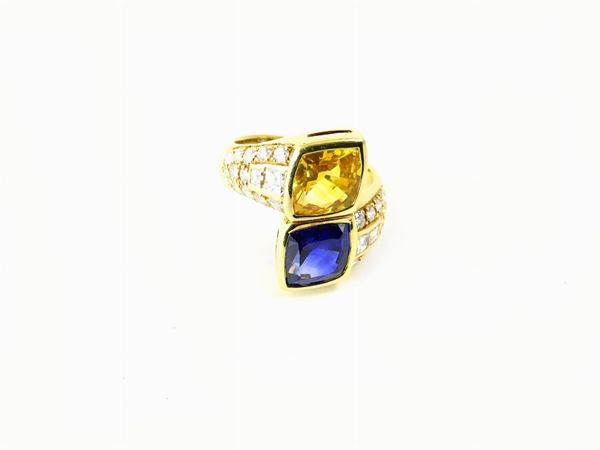 Yellow gold Segantini croisé ring with diamonds, blue and yellow sapphires
