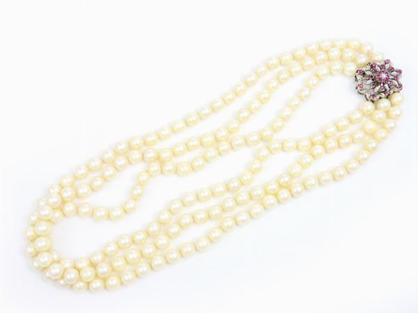 Three strands Akoya cultured pearls necklace with white gold clasp set with diamonds and rubies