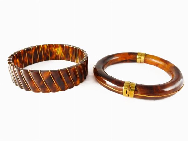 Two tortoise shell and yellow gold bangles