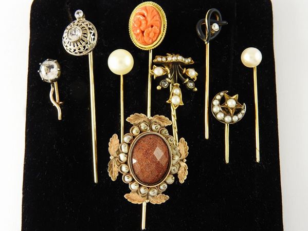 Eight various alloyed pink and yellow gold brooches with pearls, diamonds, coral, colourless stones