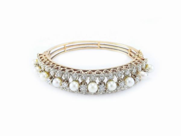 14Kt white and yellow gold bangle with diamonds