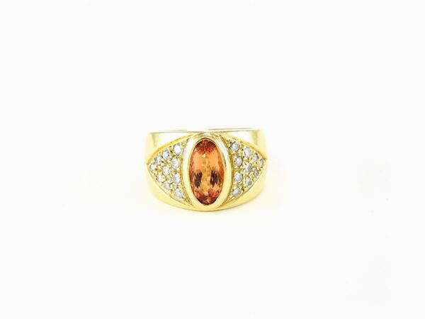 Yellow gold band ring with diamonds and imperial topaz