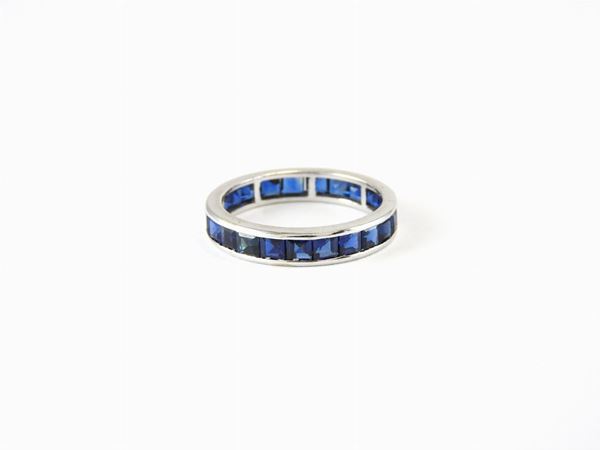 Yellow gold eternity ring with sapphires