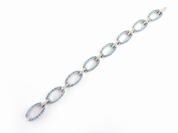 White gold bracelet with diamonds and light blue topazes