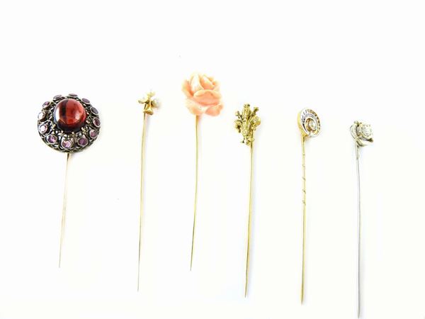 Six white and yellow gold tie pins with diamonds, pearls, coral and garnets