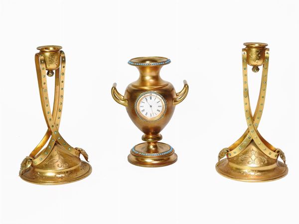 A Gilded Metal and Bronze Three Piece Clock Garniture