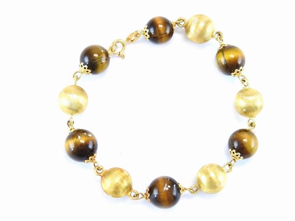 Yellow gold bracelet with tiger's eye