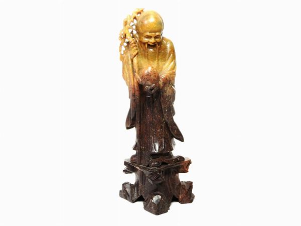 A Soapstone Figure of a Wiseman Holding a Peach