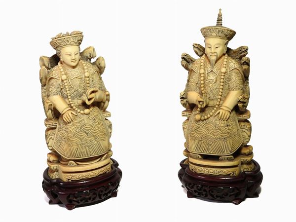 *A Pair of Carved Ivory Seated Figures