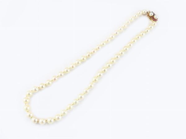 Akoya cultured pearls necklace with 14Kt yellow gold clasp set with sapphires, rubies and pearls