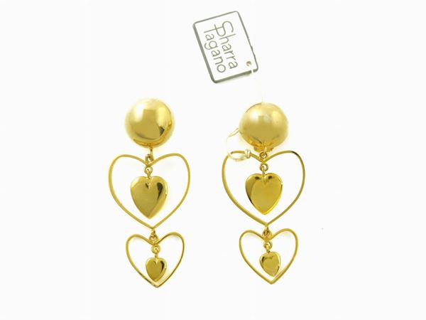 Goldtone metal pair of earrings, Sharra Pagano