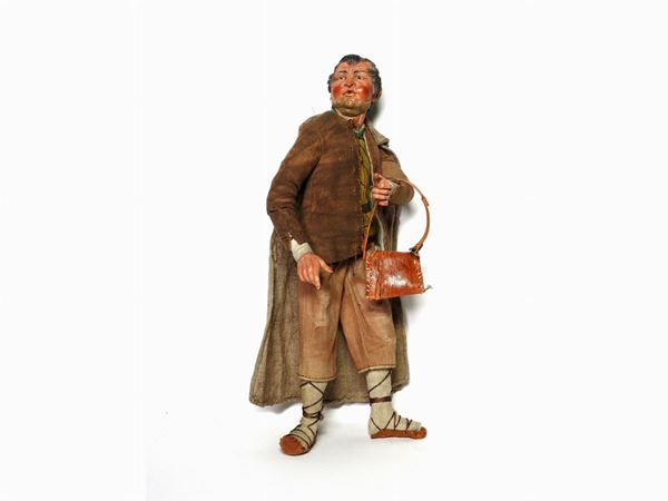A Polychrome Earthenware and Wooden Figure of a Shepherd
